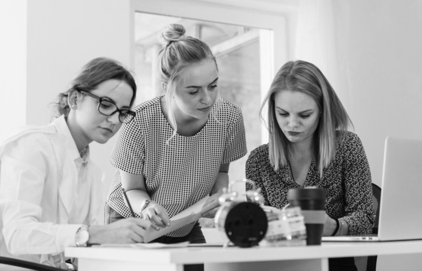 Front-end development workspace showing multiple monitors with code and design mockups